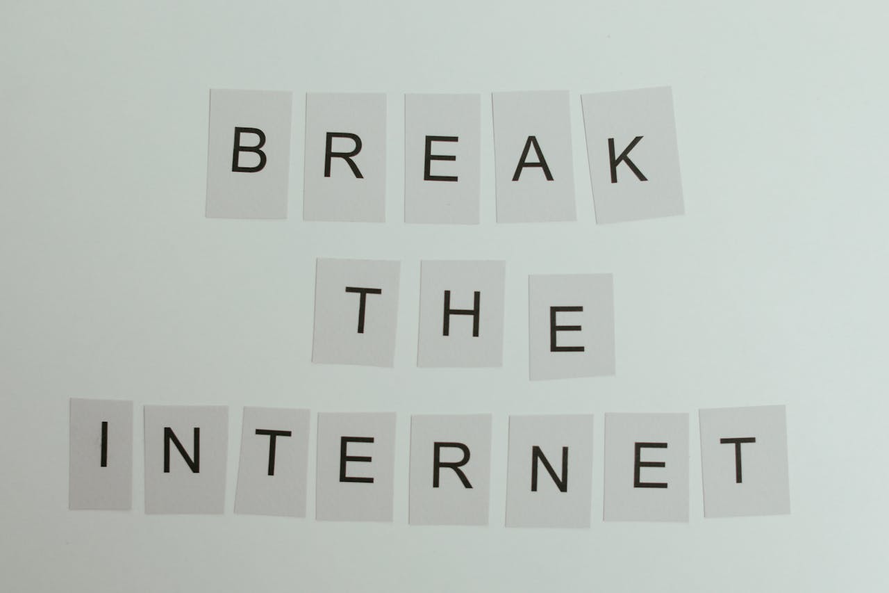 Conceptual image with text 'Break the Internet' using letter cards on a light background.
